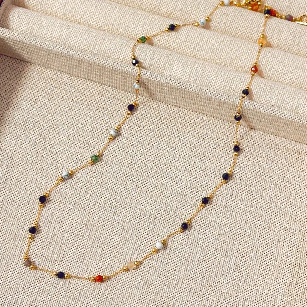Gold electroplated titanium steel necklace with a natural stone pendant on an O-ring chain.