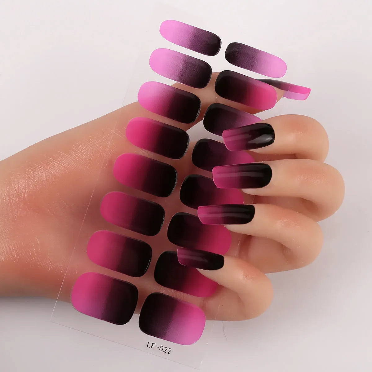 Full coverage nail art stickers sheet with 16 designs including cross, rose, tulip, and cartoon patterns.