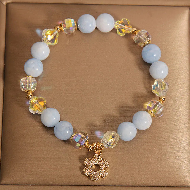 Women's aquamarine crystal bracelet with four-leaf clover charm and pearl accents in light luxury design