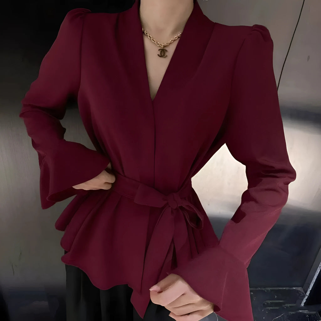 Women's black French-style shirt with irregular collar, tied front, and long bell sleeves.