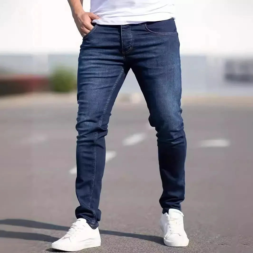 Dark blue men's slim-fit casual jeans with a worn finish and skinny leg opening.