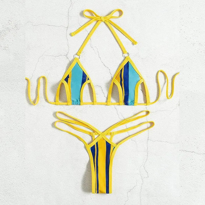 Yellow women's two-piece swimsuit with high-waisted shorts and a sleeveless, backless top on a neutral background.