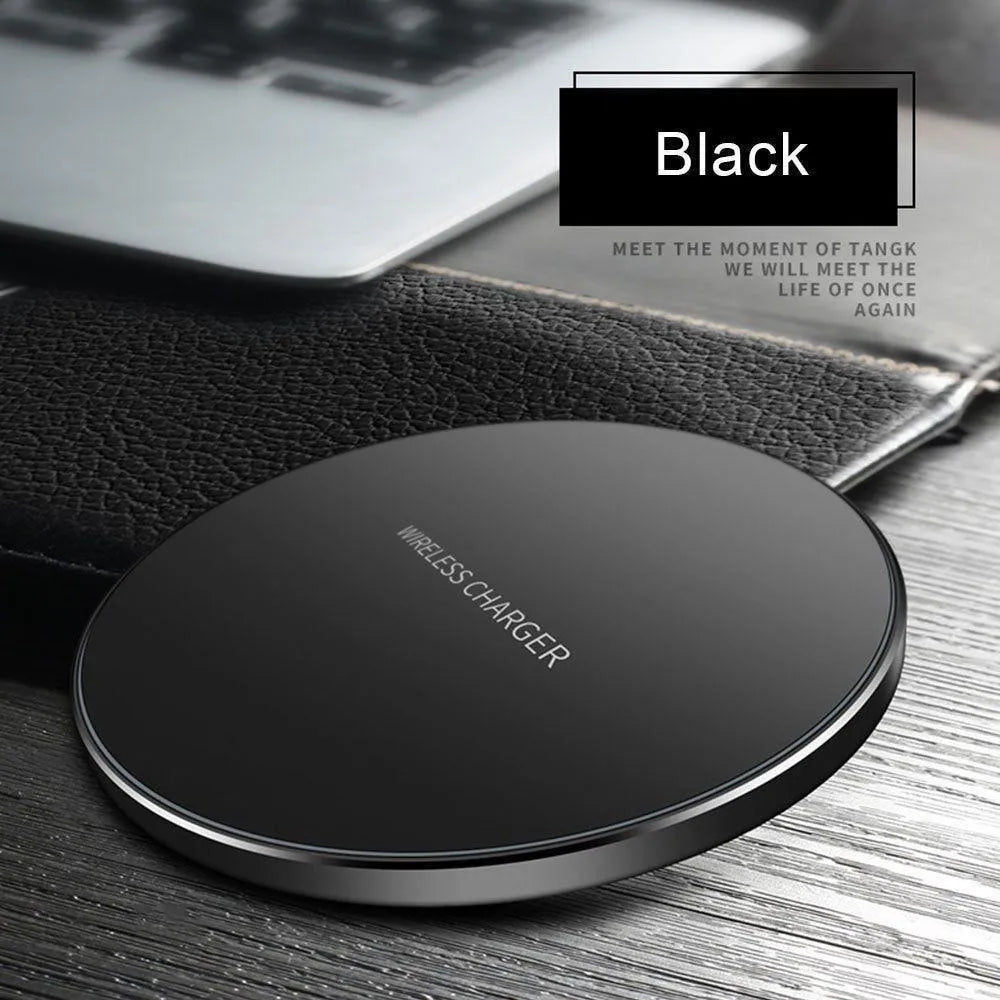 Black ultra-thin 9V QI wireless fast charger with USB cable on a desk.