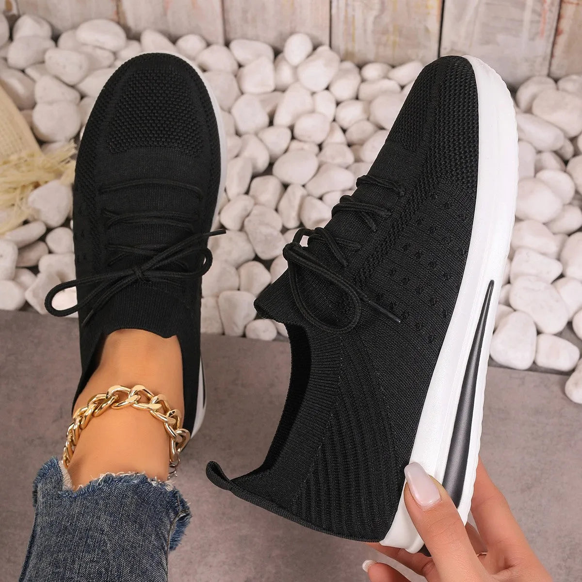 Women's low-top casual sneakers in black, blue, and red with a fly-knit PU upper and front lace-up closure.