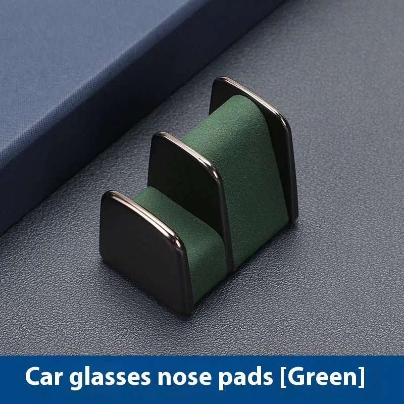 Zinc alloy and leather sunglasses clip holder for car dashboard in black, grey, green, or red.