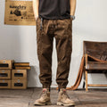 Men's khaki coloured loose-fit tapered harem pants with a small ankle band and elasticated waist.