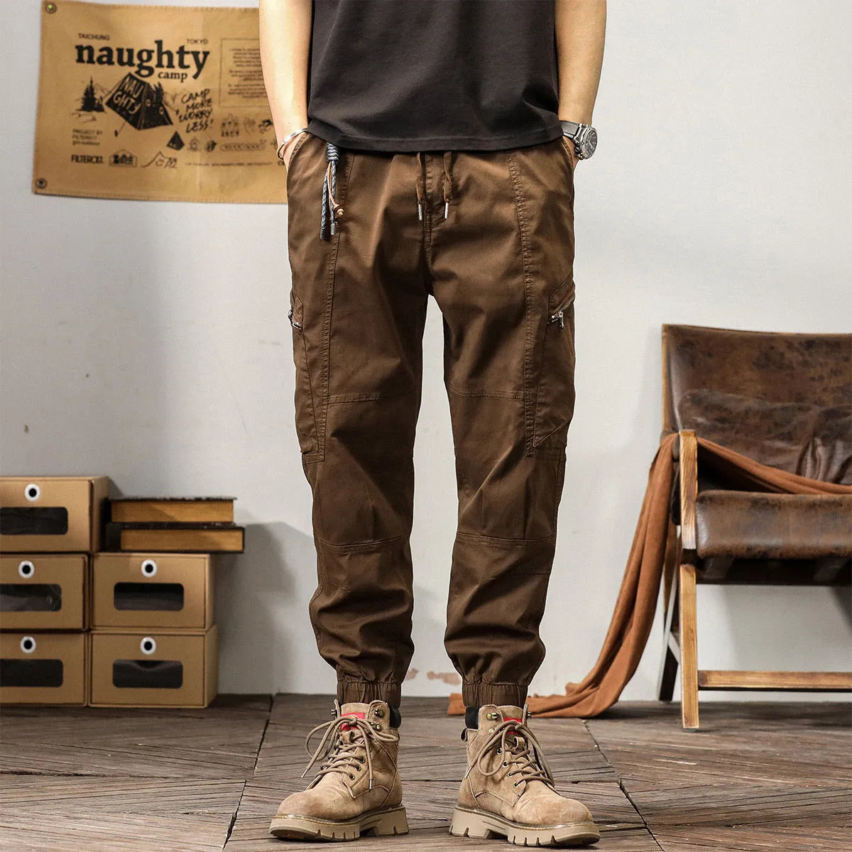 Men's khaki coloured loose-fit tapered harem pants with a small ankle band and elasticated waist.