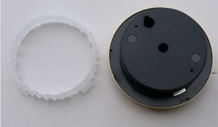 Circular aluminium analogue thermometer and hygrometer showing humidity and temperature dials