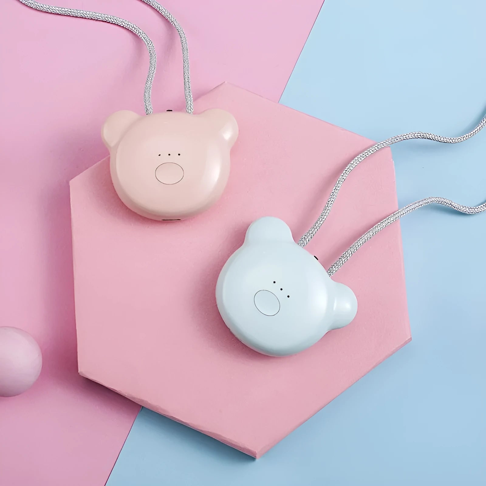 Pink and blue wearable USB air purifier necklace shown on a person, with dimensions 1.5 by 5.7 by 4.5 cm.