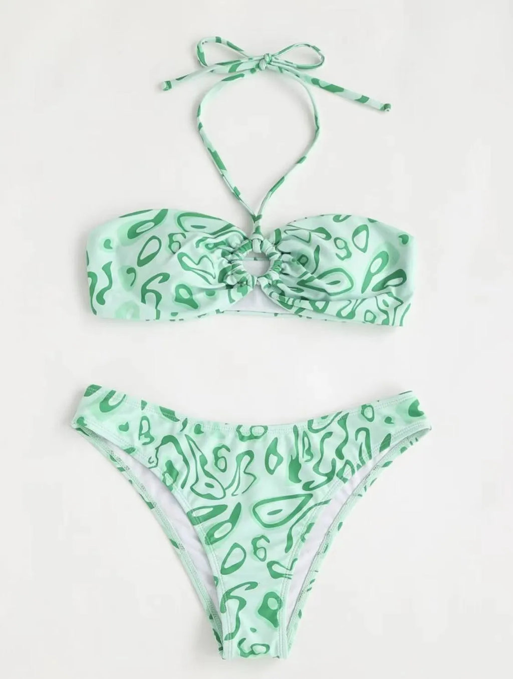 Women's blue floral bandeau bikini swimsuit with split design on beach background