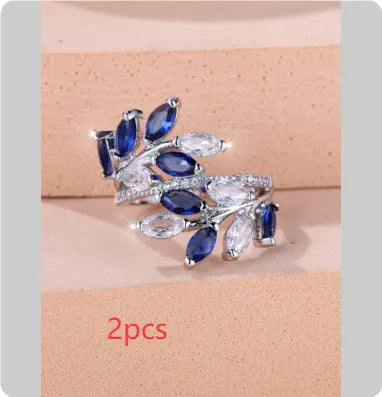 Adjustable opening copper leaf fashion ring with sparkling zirconia stones in a rose gold finish.