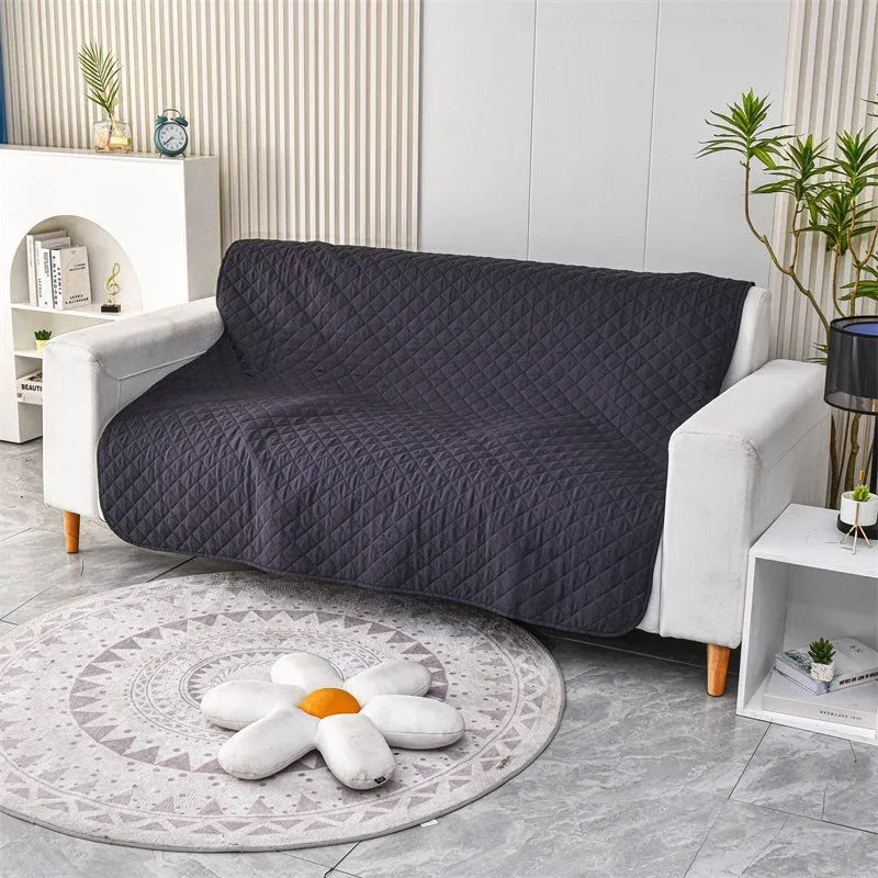 Reversible waterproof dog blanket on sofa showing two colour options with multiple size measurements