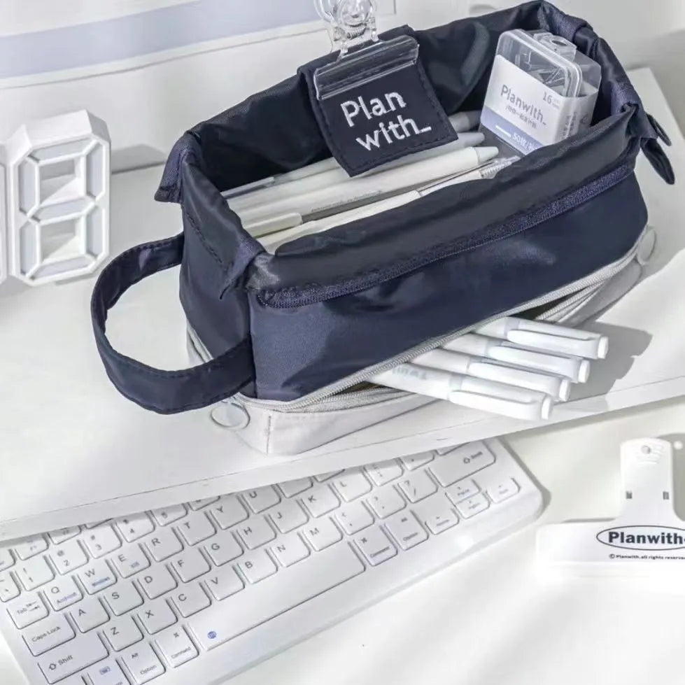 A navy blue double-layer folding pencil case made from polyester fabric for student stationery.