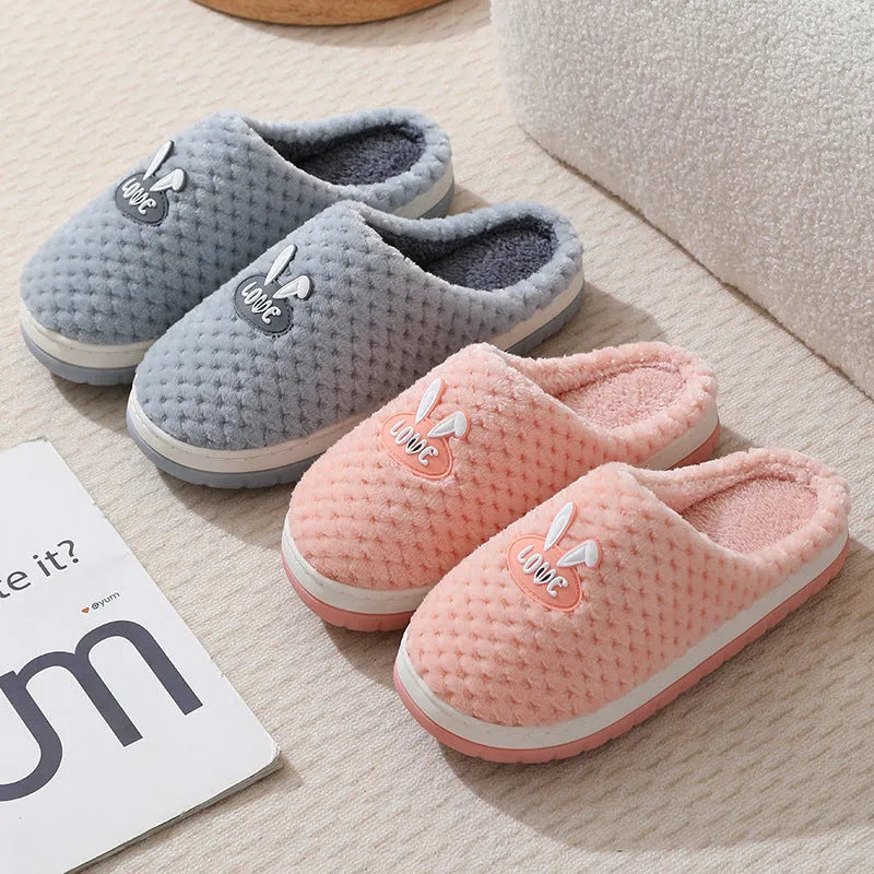 Women's rabbit plaid design artificial fur house slippers with a thick rubber sole.