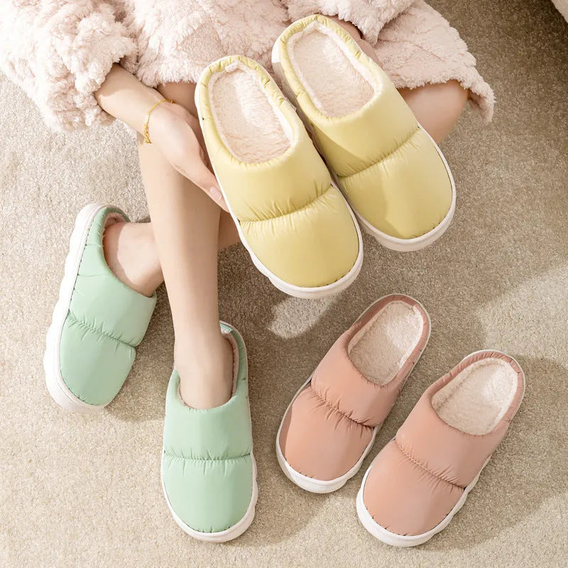 A pair of down cotton slippers with an artificial leather upper and thick rubber sole, shown in blue.