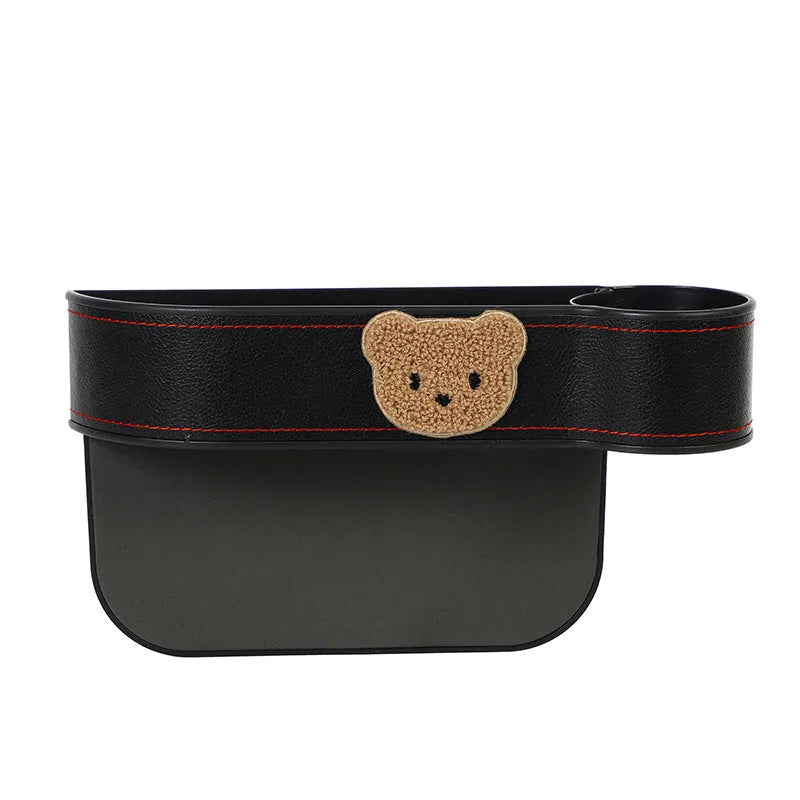 Leather car seat gap storage box with cartoon bear design for organising phones and keys.