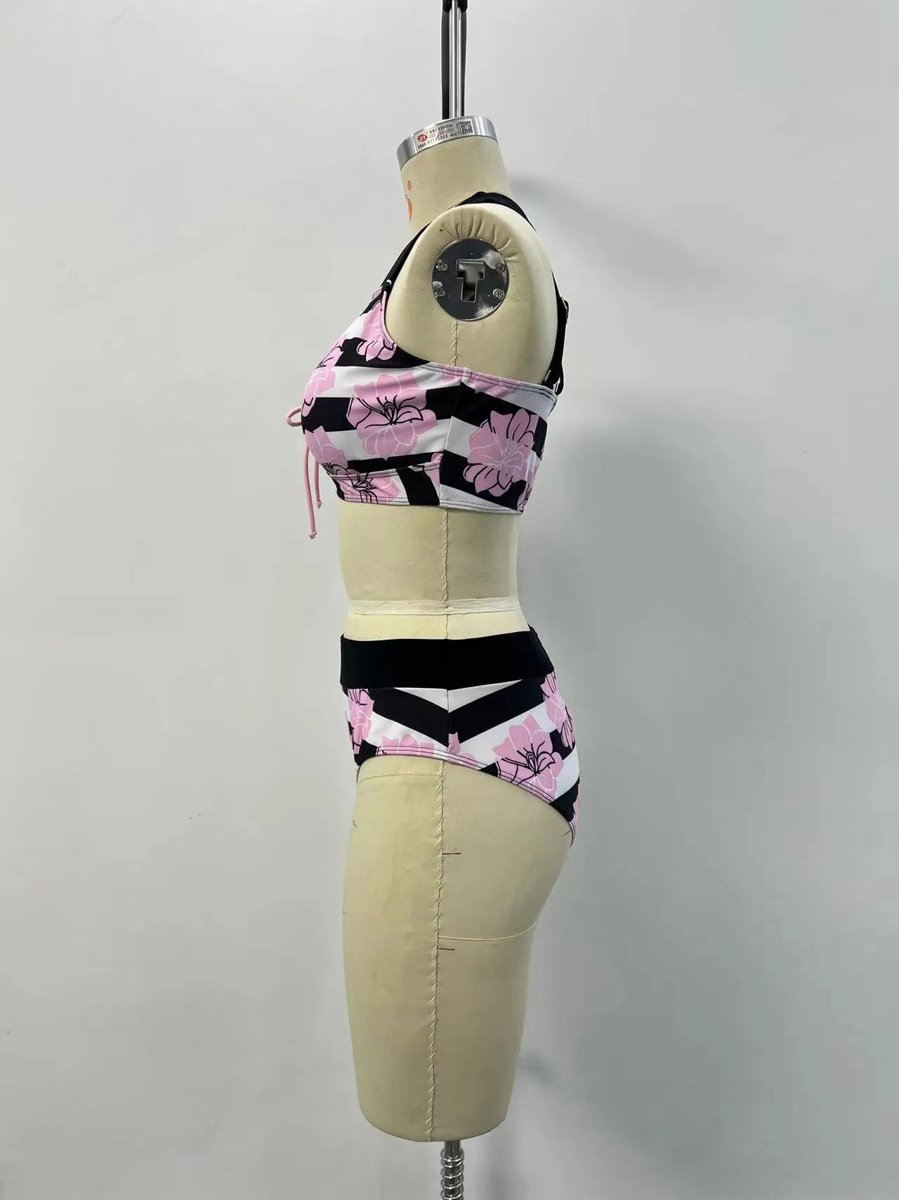 Black printed women's bikini with slimming belly panel and split-leg bottoms.