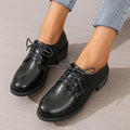Black women's low-top work shoes with a thick chunky heel and round toe.