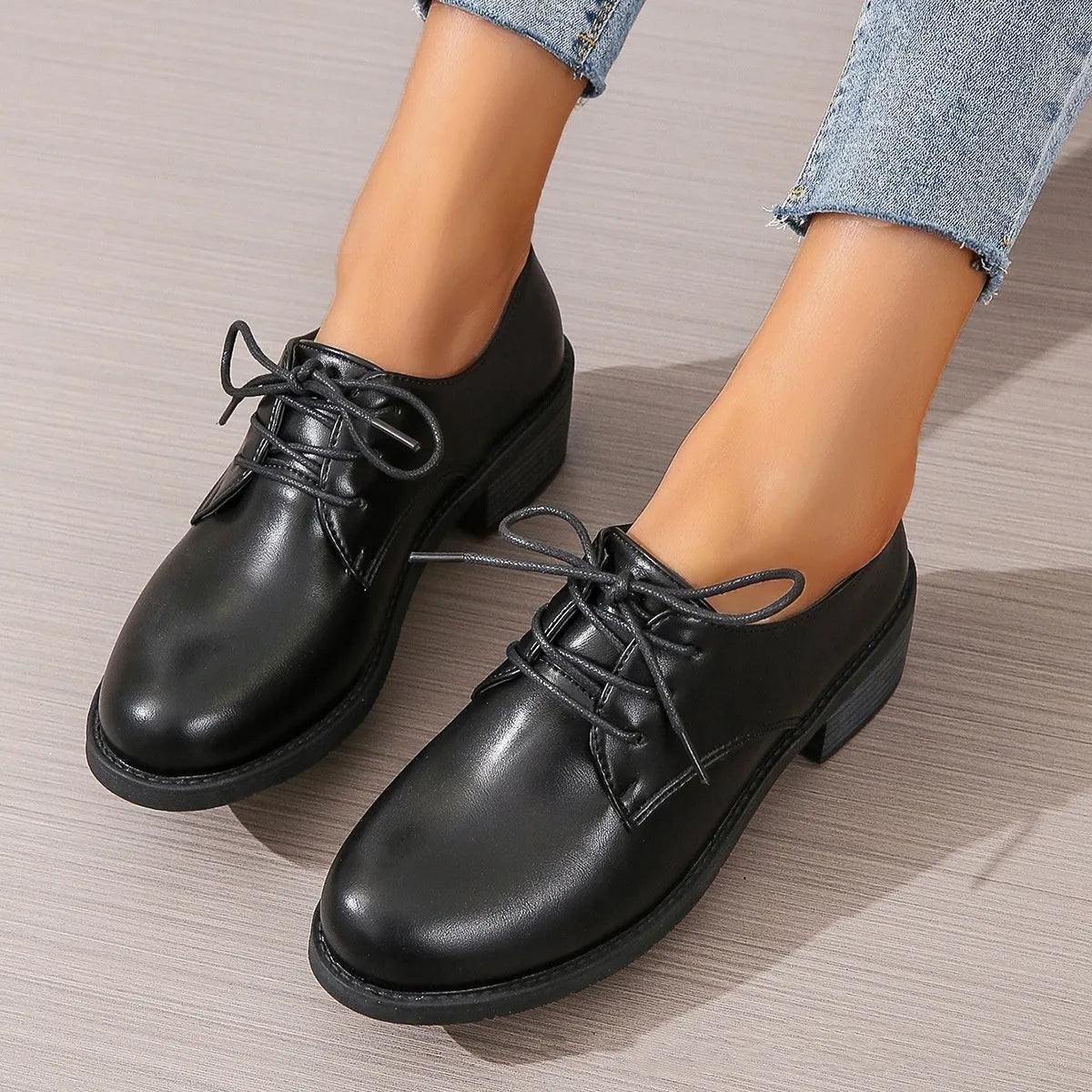 Black women's low-top work shoes with a thick chunky heel and round toe.
