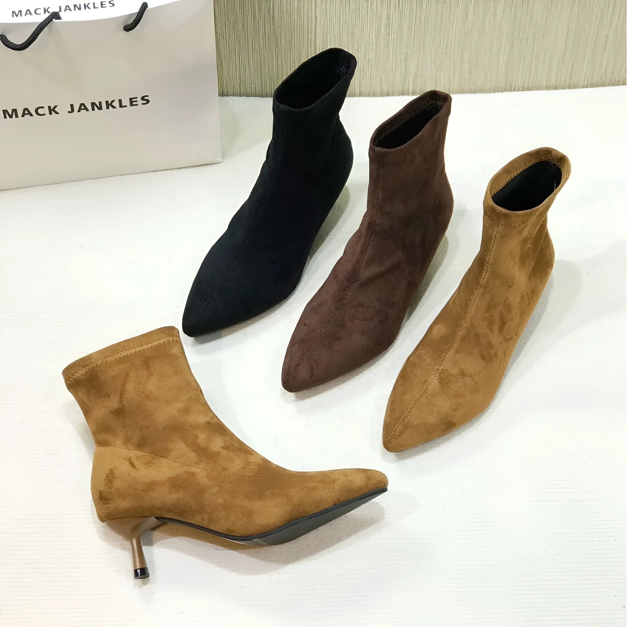 Black pointed toe stiletto heel ankle boots with microfiber upper and mid-calf length
