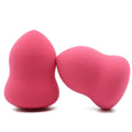 Pink cubic makeup foundation sponge puff on a clean surface.
