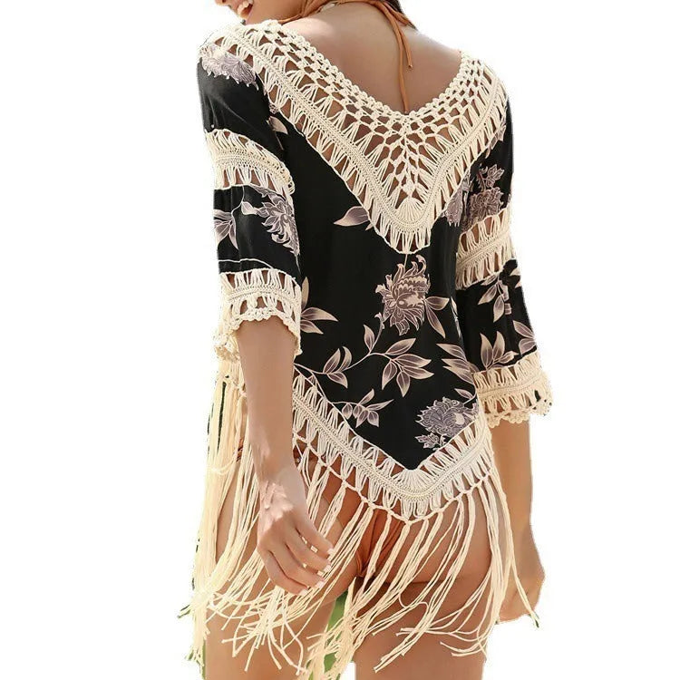 Women's apricot coloured V-neck sun protection blouse with loose hollow-out sleeves on a beach background.