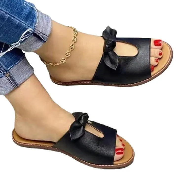 Ladies fish mouth style sandals with a decorative bow on the upper, in black colour.