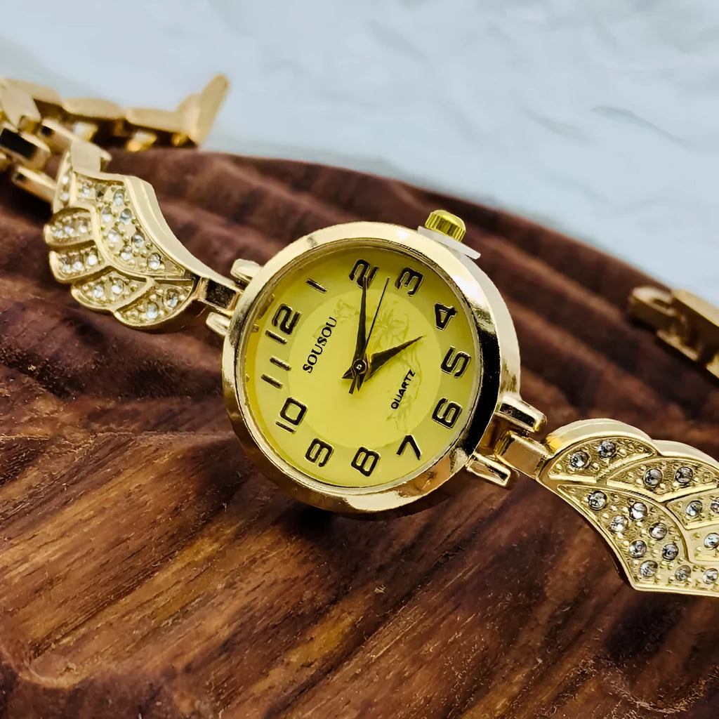 Stainless steel women's watch with round dial on wrist showing gold surface colour