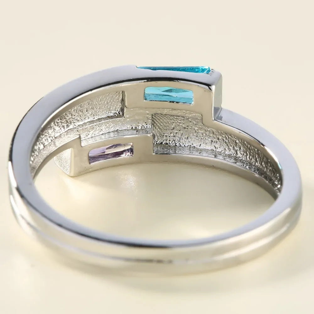 Silver-coloured copper ring with decorative zircon stone inlays on finger