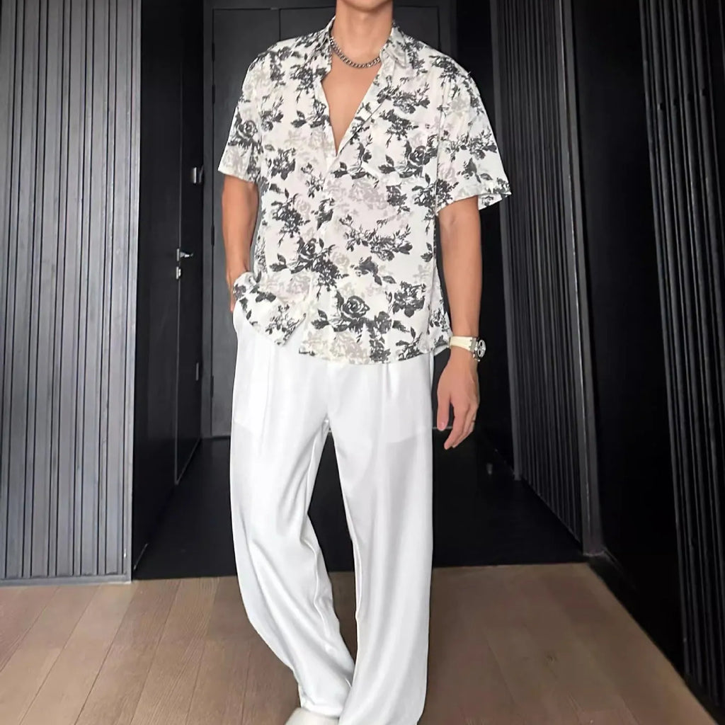 Man's loose-fit short sleeve shirt with printed floral pattern and pendant detail in black
