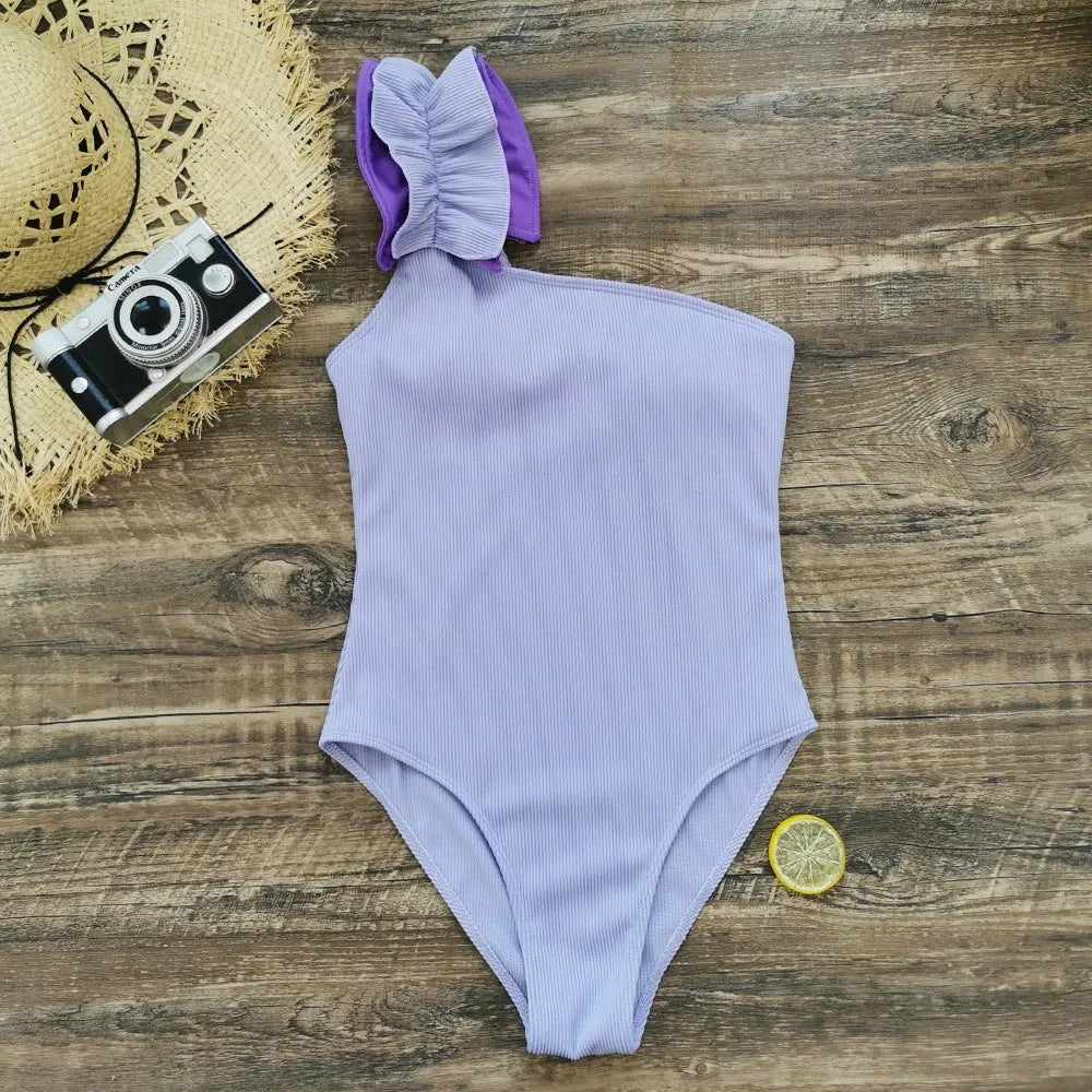 Women's single-shoulder high waist one-piece swimsuit in solid colour on a mannequin.