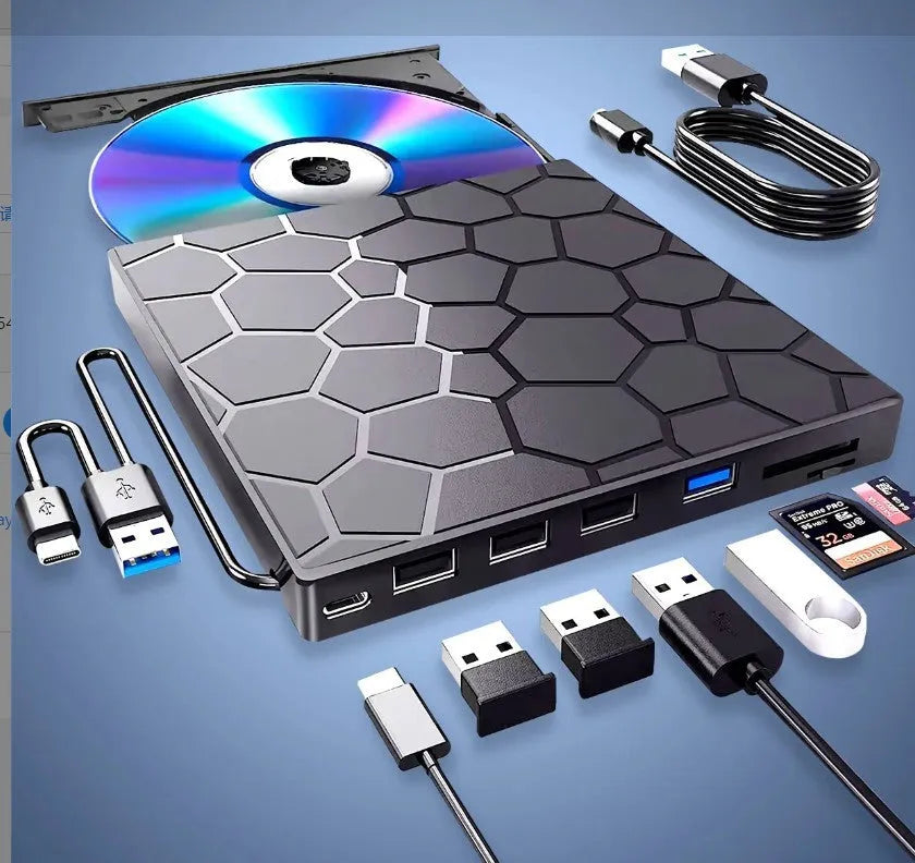 Black external USB CD/DVD burner drive on a desk next to a laptop