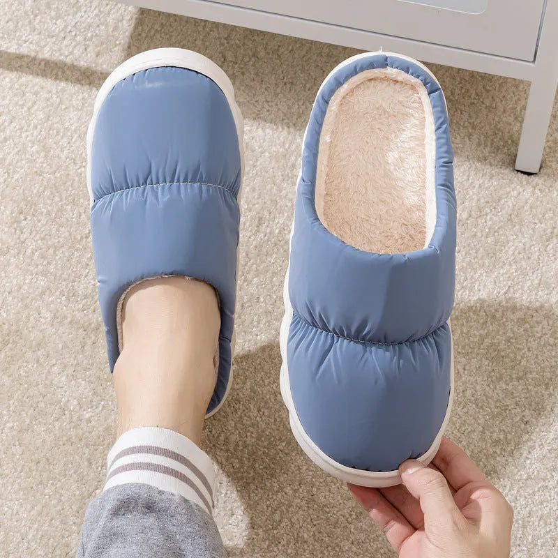 A pair of down cotton slippers with an artificial leather upper and thick rubber sole, shown in blue.