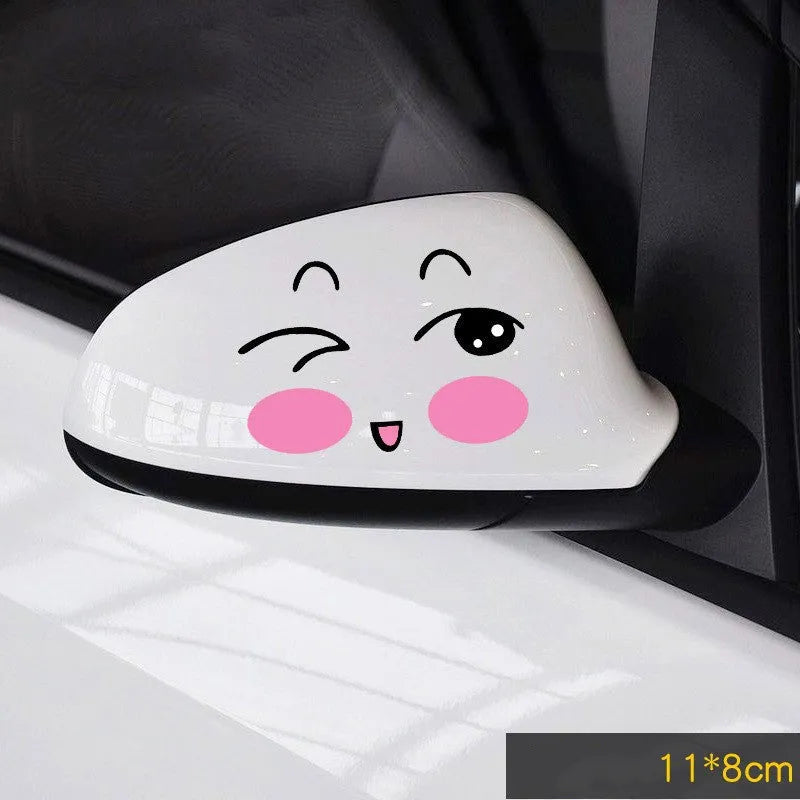A pair of reflective cartoon car eye stickers on a vehicle body.