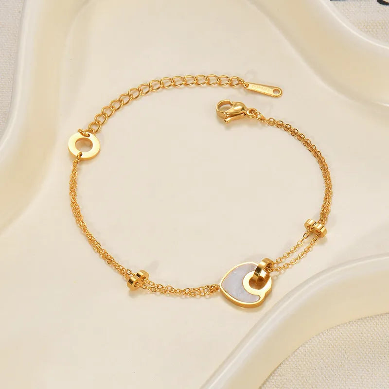 Women's stainless steel bracelet with a double-layered red heart resin charm.