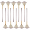 Set of 10 professional facial fan brushes with champagne finish and acrylic handles on a table.
