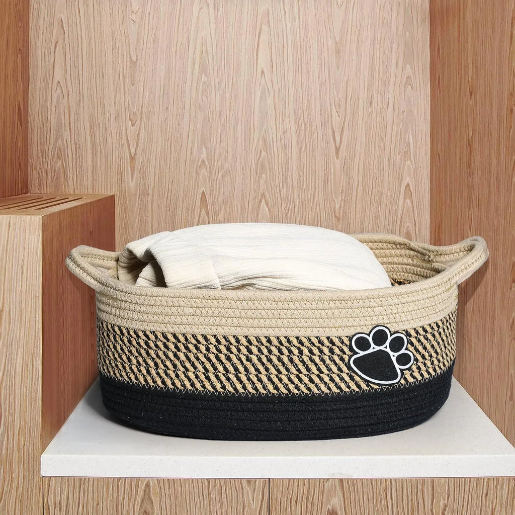 Small light beige handmade woven cotton rope storage basket with wooden handle