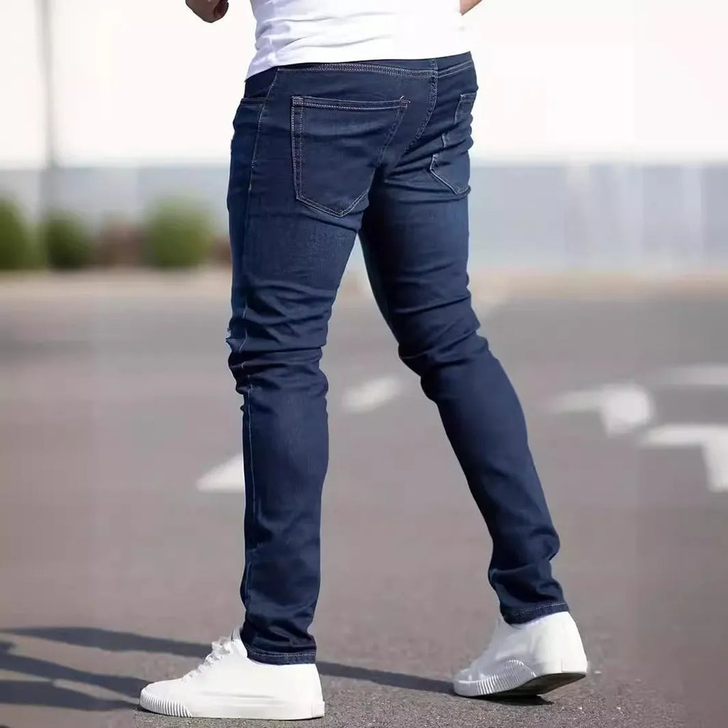 Dark blue men's slim-fit casual jeans with a worn finish and skinny leg opening.