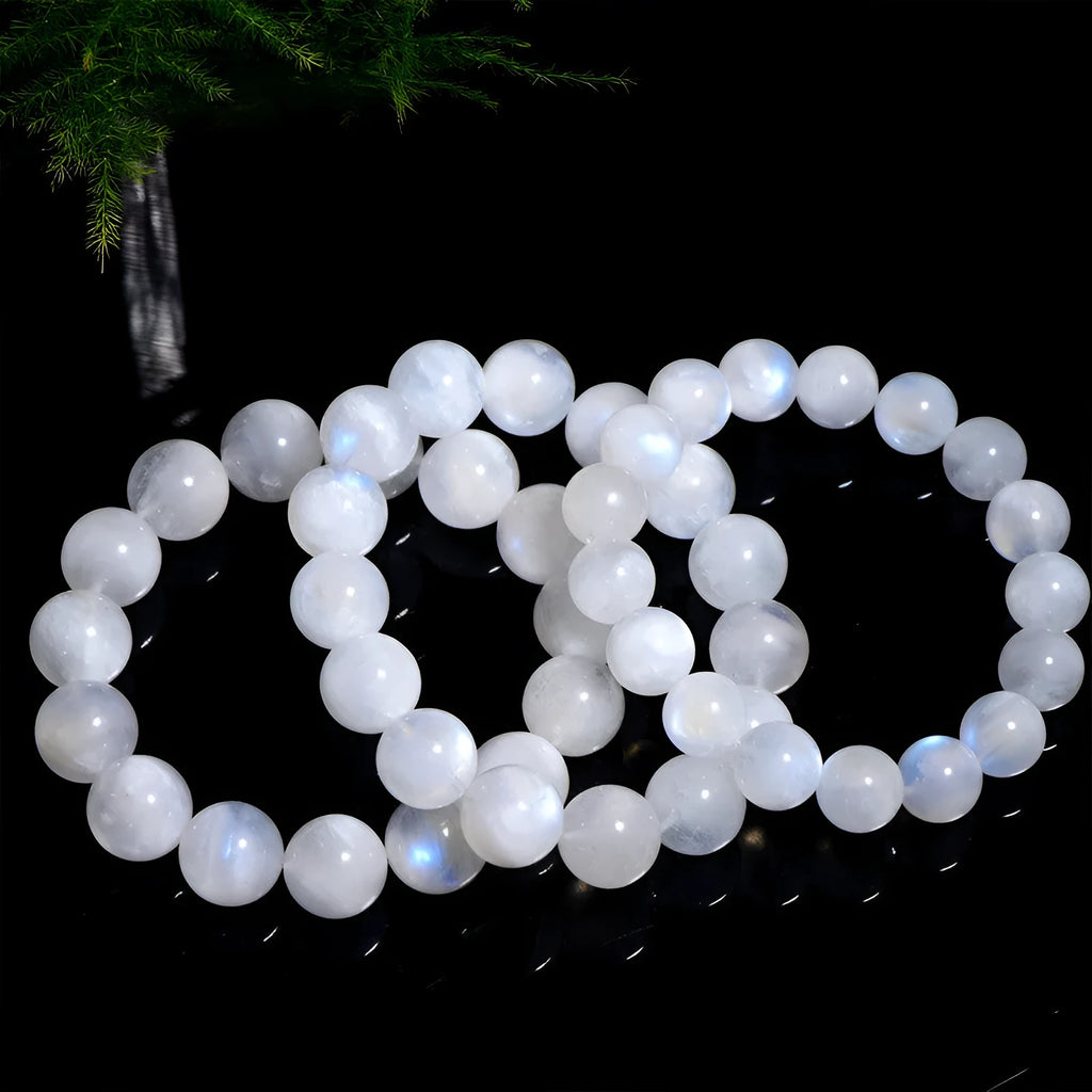 Natural white moonstone round bead bracelet showing blue moonlight sheen and polished surface