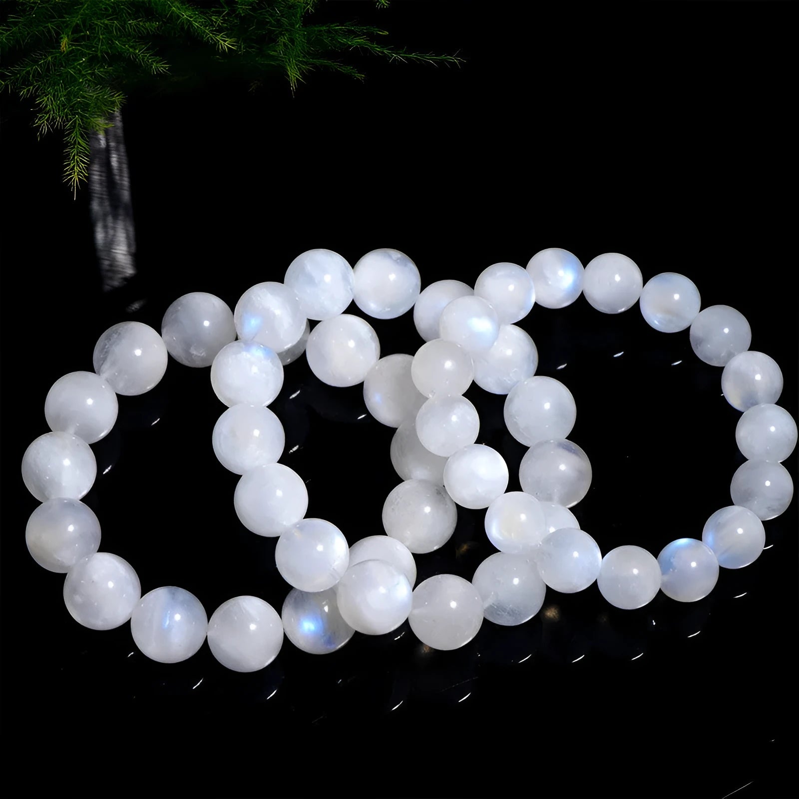 Natural white moonstone round bead bracelet showing blue moonlight sheen and polished surface