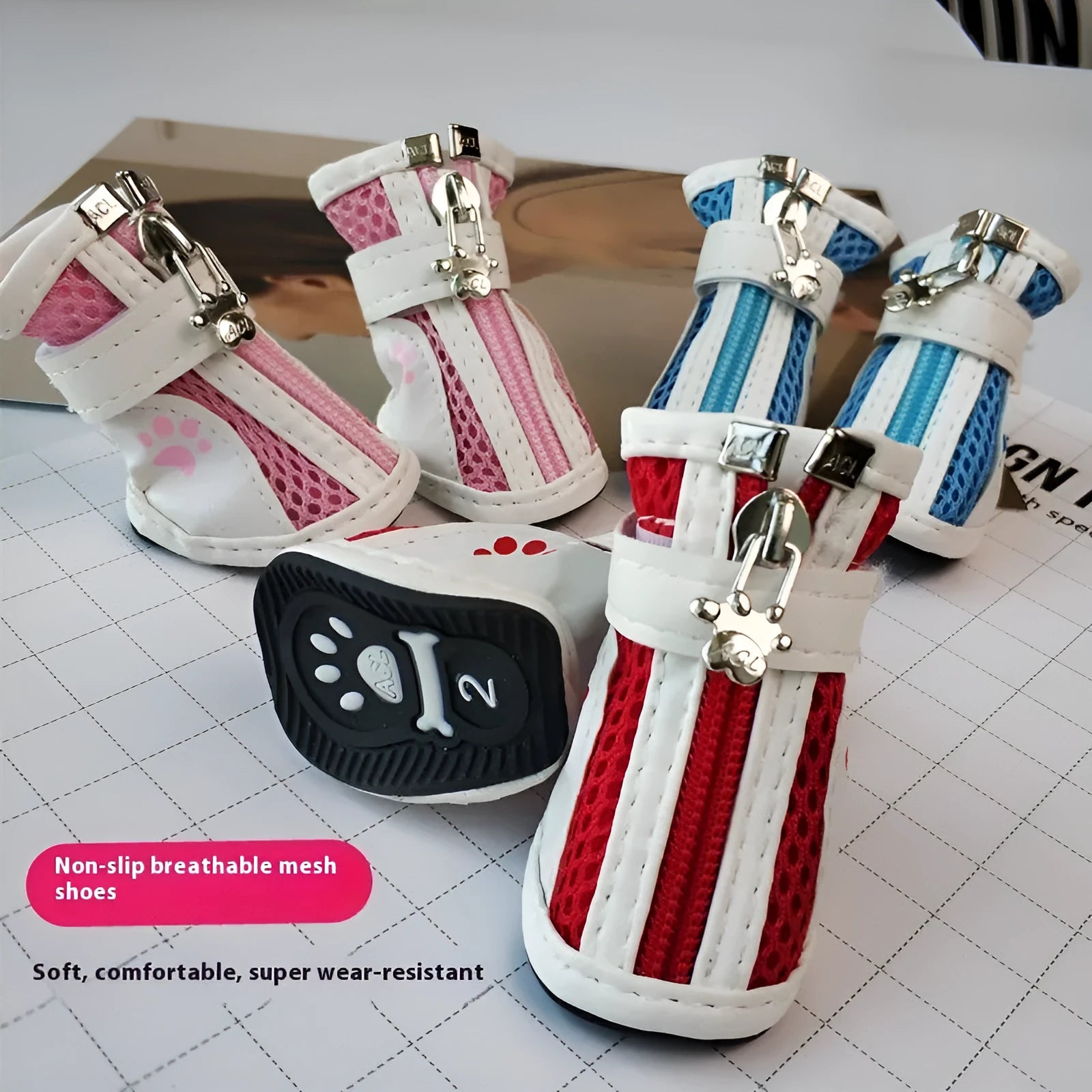 Set of four blue cloth dog shoes for small dogs with non-slip soles and a zip fastening.