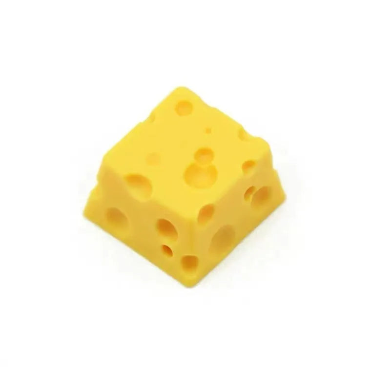 Close-up of a yellow solid resin cheese-themed keycap for mechanical keyboards.