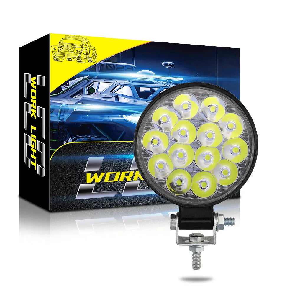 White mini round 42W LED work light with aluminium housing for vehicle mounting.
