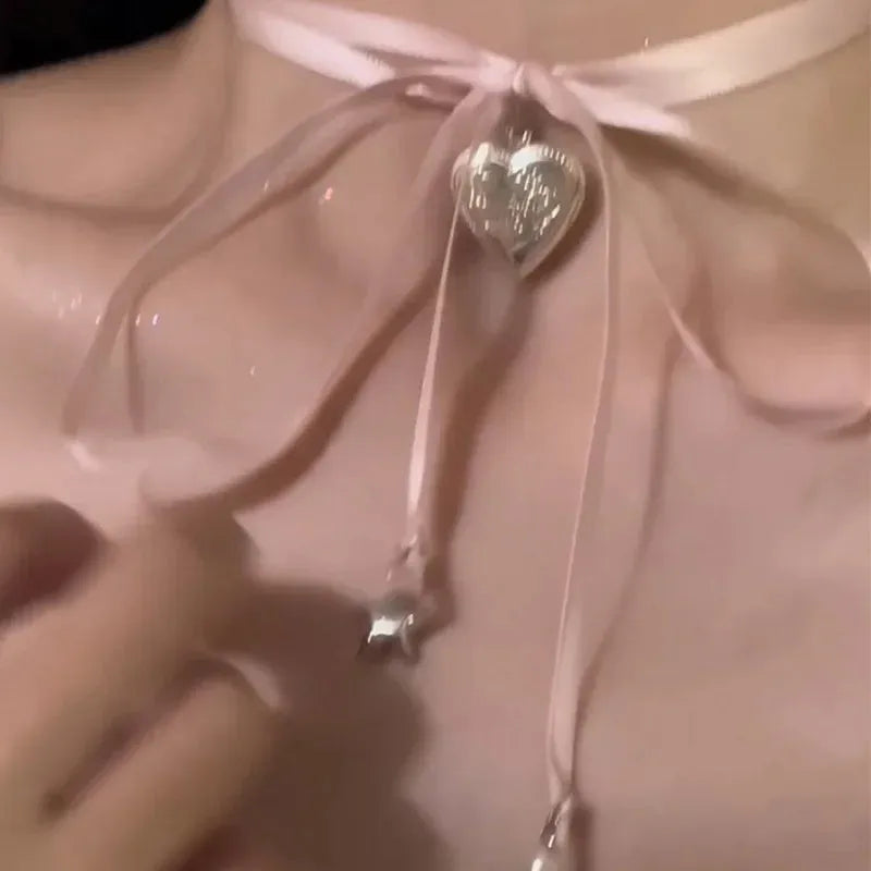 Women's alloy ribbon love pendant necklace on a clavicle chain, shown in one of 33 available colours.