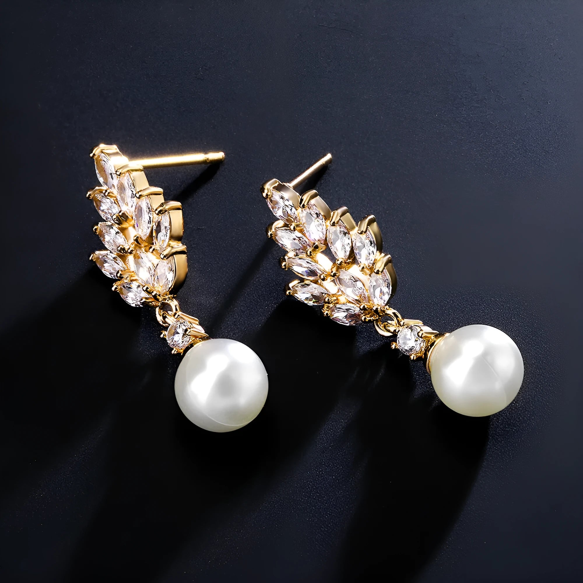 Geometric flower shaped earrings with micro inlaid zircon stones and pearl accents on a gold plated background.