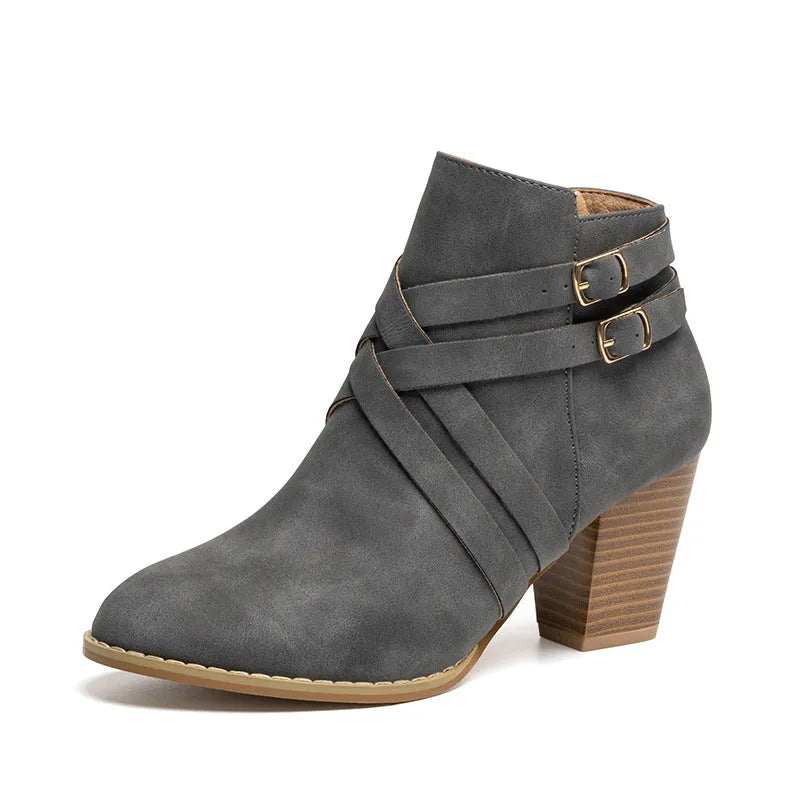 Plus size women's short ankle boots with a 7cm block heel, side zipper, and belt buckle detail in black.