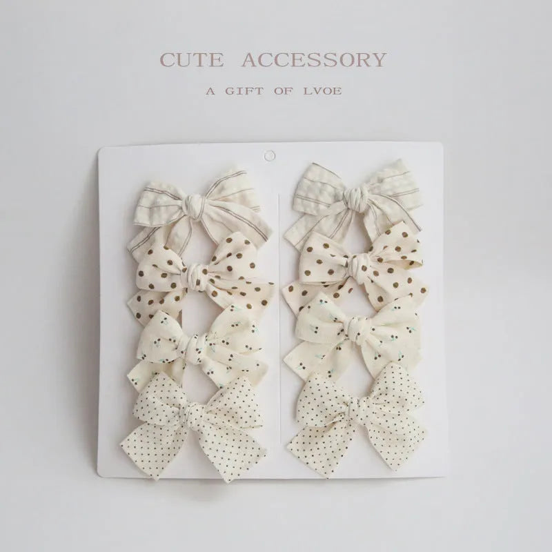 Set of eight fabric dovetail bow hairclips for children in various colours