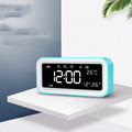 Blue rectangular LED atmosphere alarm clock with digital display on a desk.