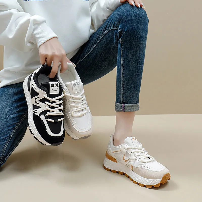 Women's black platform casual lace-up trainers with a round toe and flat heel on a white background.