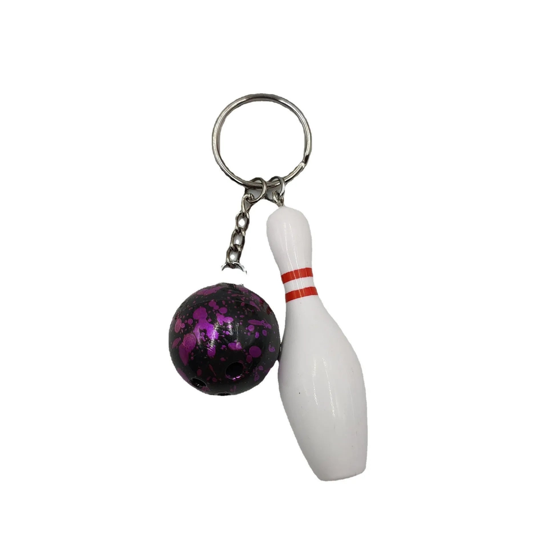 Miniature blue bowling ball keychain pendant with metal keyring on a dark surface.